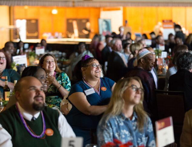 Guests at event fondly looking at stage