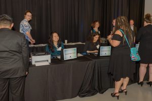 Candid photo of event volunteers working a registration station