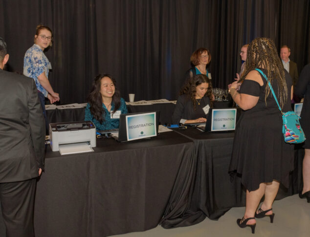 Candid photo of event volunteers working a registration station